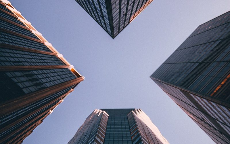 low-angle photography of four high-rise buildings